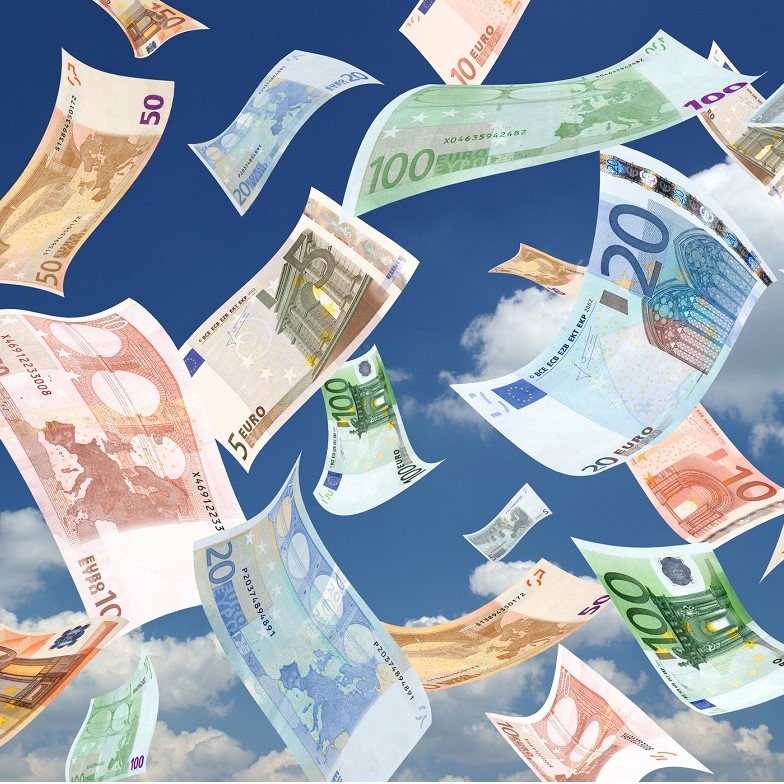 An assortment of euro banknotes in various denominations is depicted, floating against a clear blue sky with scattered clouds. The bills showcase colorful designs, emphasizing financial abundance and prosperity.